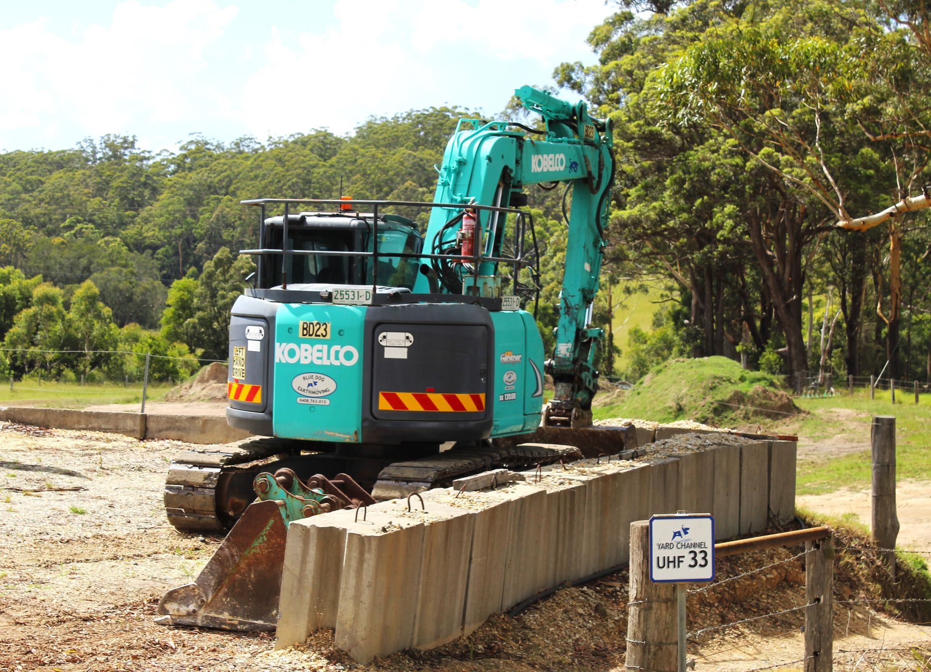 A Kobelco excavator is sitting on top of a concrete block — Blue Dog Landscape Supplies In Newee Creek, NSW