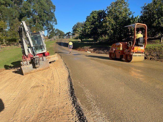 A Bulldozer And A Roller Are Working On A Road — Blue Dog Landscape Supplies In Newee Creek, NSW