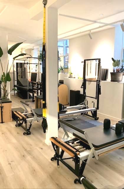 A room with a lot of pilates equipment in it