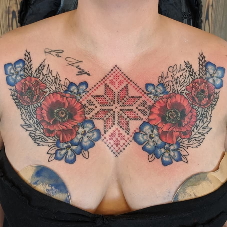 Ukrainian Cross Stitch and Floral Tattoo by Sheila Anderson at Crimson Empire Tattoo in Edmonton Alberta Canada