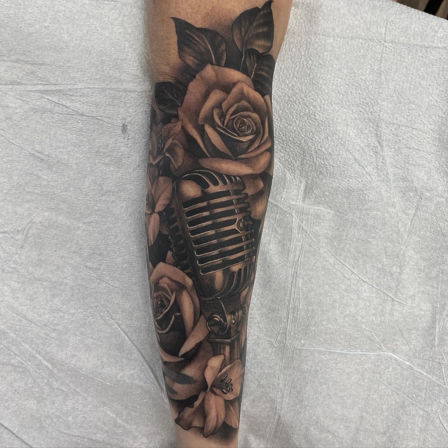 Microphone and Floral Tattoo by Sasha Day at Black Gold Tattoo Co in Edmonton Alberta Canada