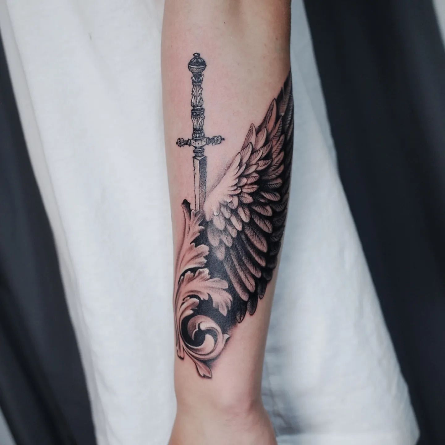 Wing and Sword Tattoo by Ian Wang at Black Gold Tattoo Co in Edmonton Alberta Canada