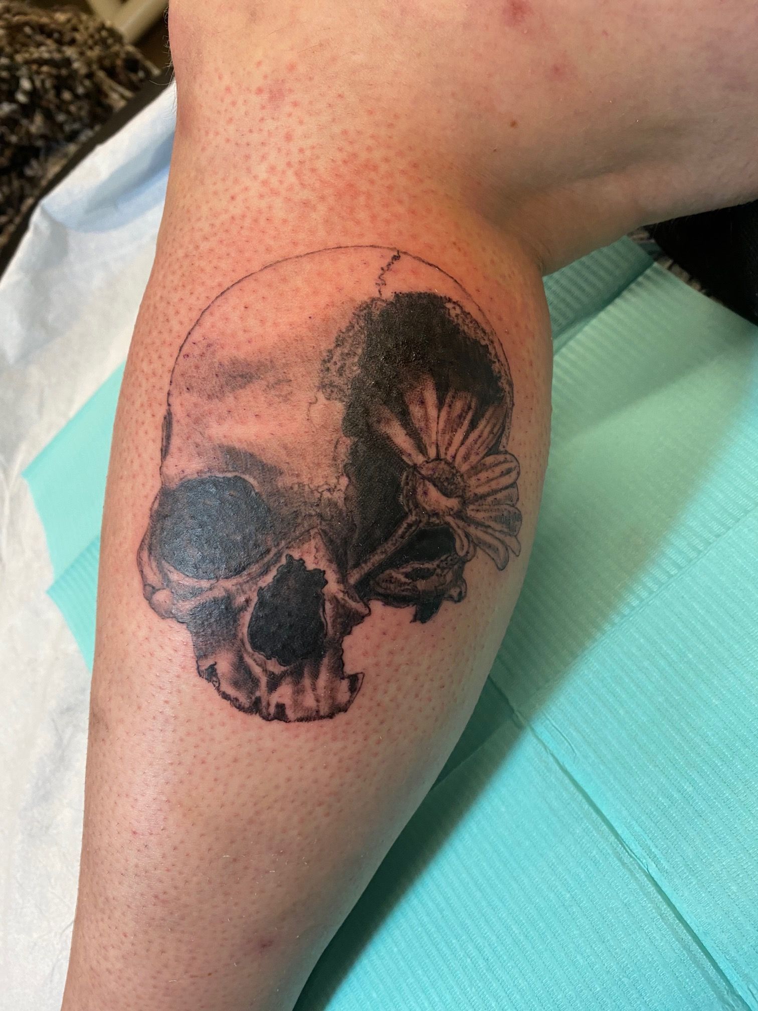 Skull and Floral Tattoo by Keon Courtney at Crimson Empire Tattoo in Edmonton Alberta Canada