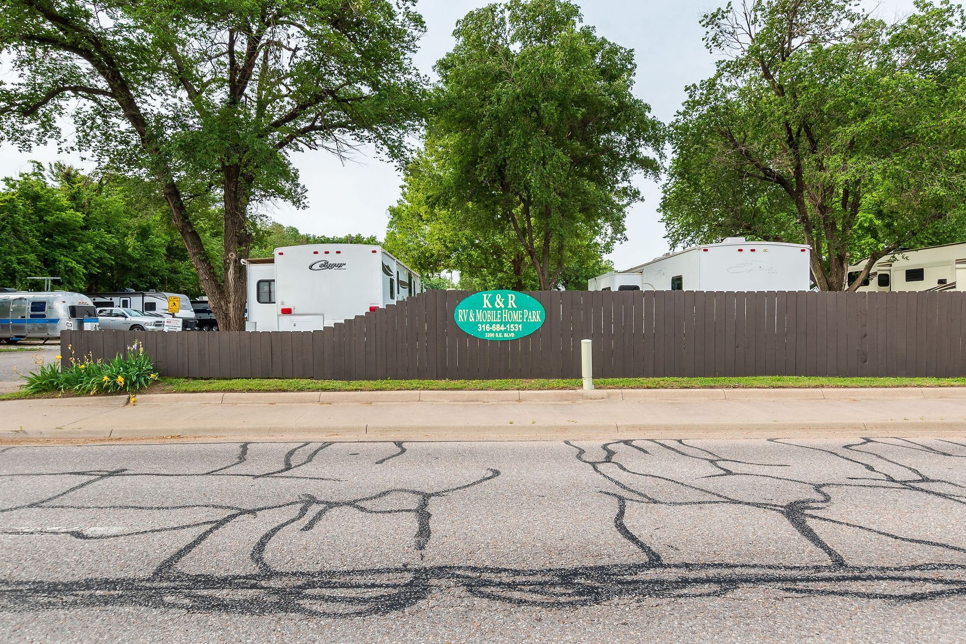 A fence with a sign on it that says ' rv parking '