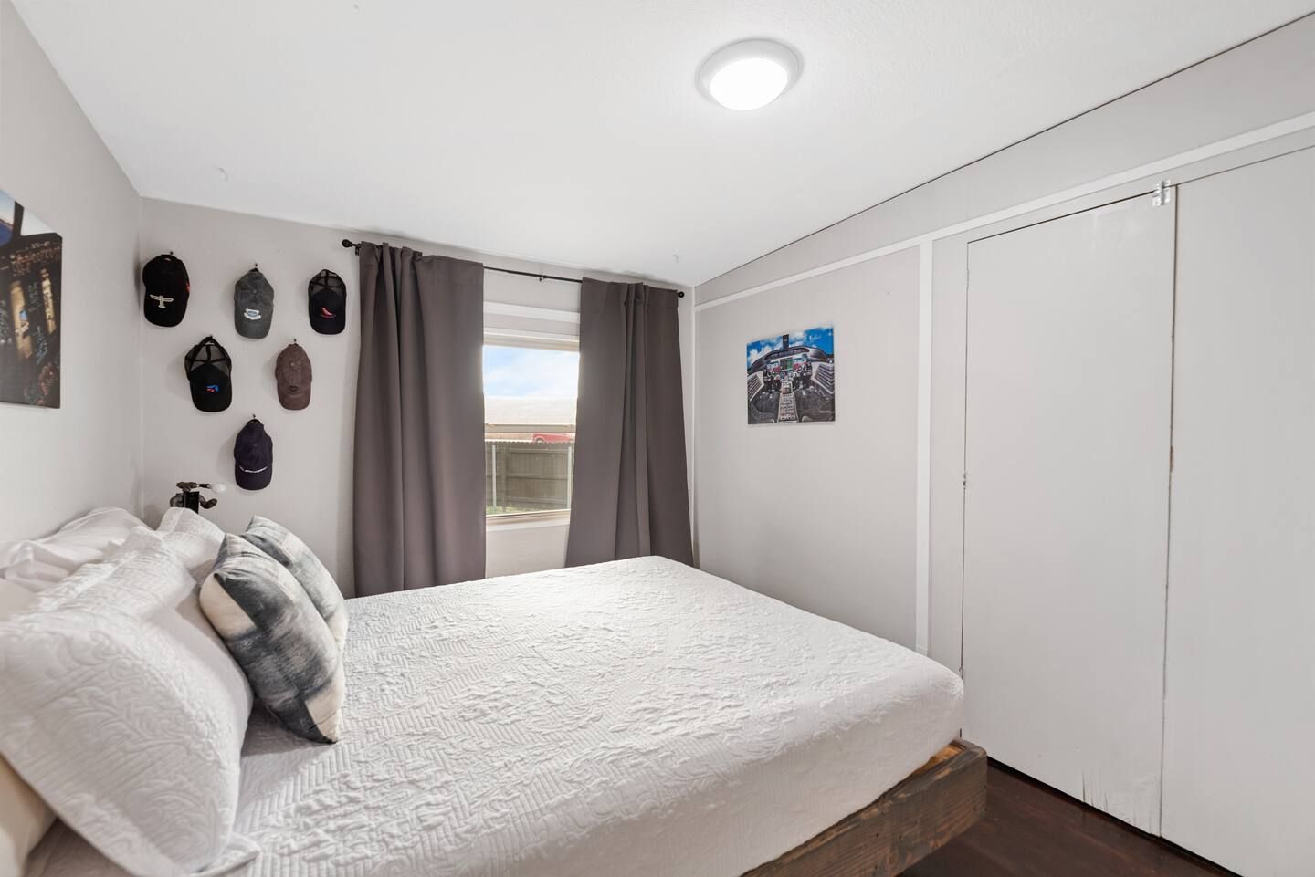A bedroom with a large bed and a window.