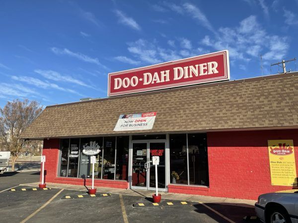 A red building with a sign that says doo-dah diner