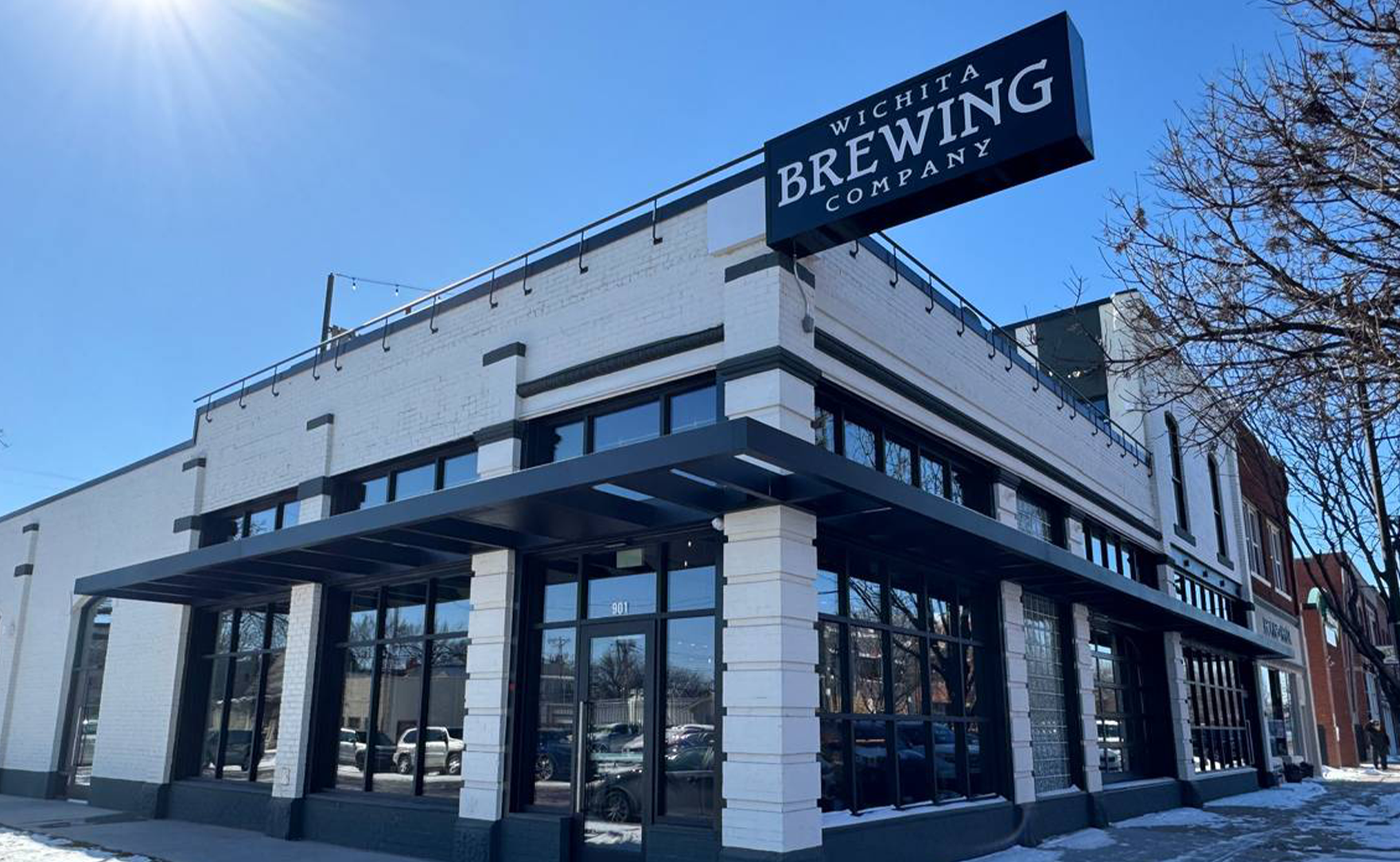 A large white building with a sign that says brewing company on it.