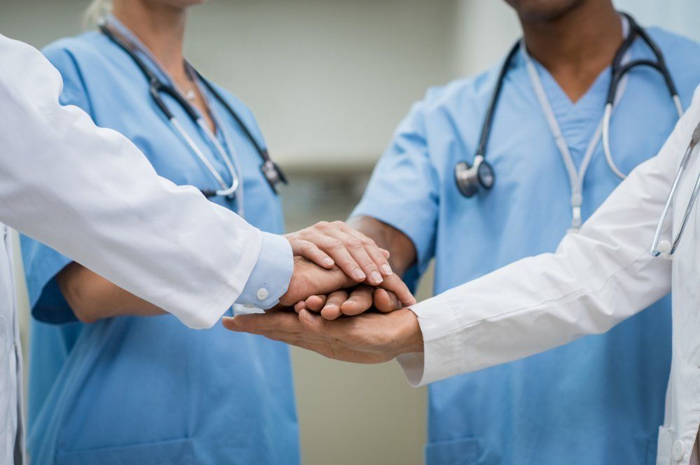 Diabetes Specialist — Doctors Holding Hands Together In Winston Salem, NC
