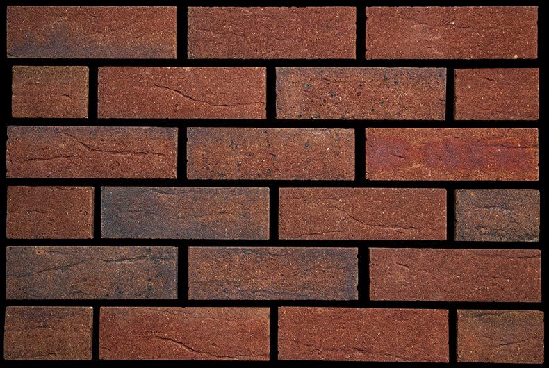 A close up of a brick wall with a black background
