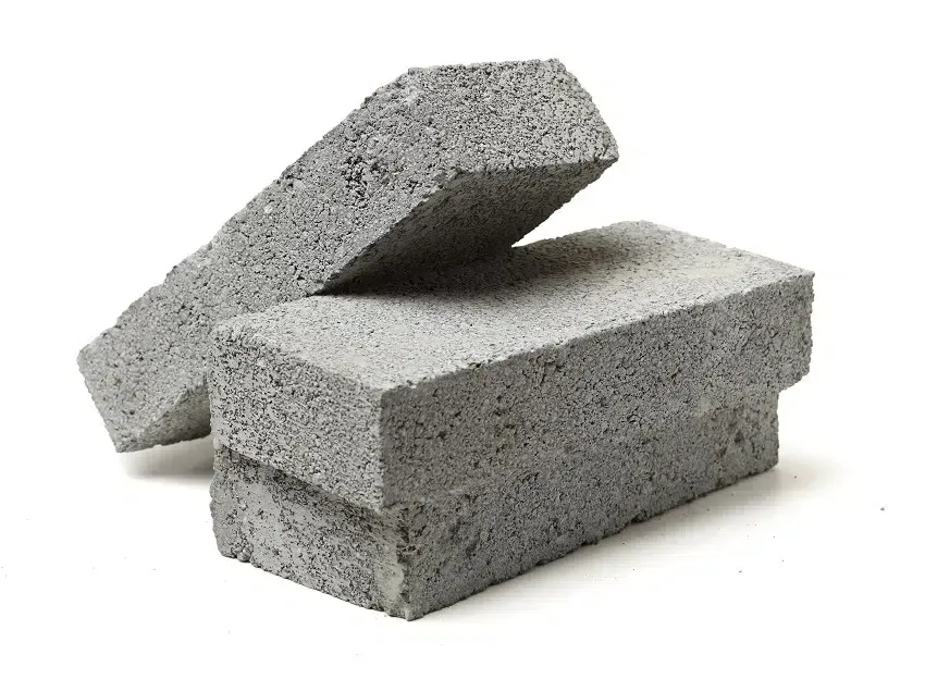 Three bricks are stacked on top of each other on a white background