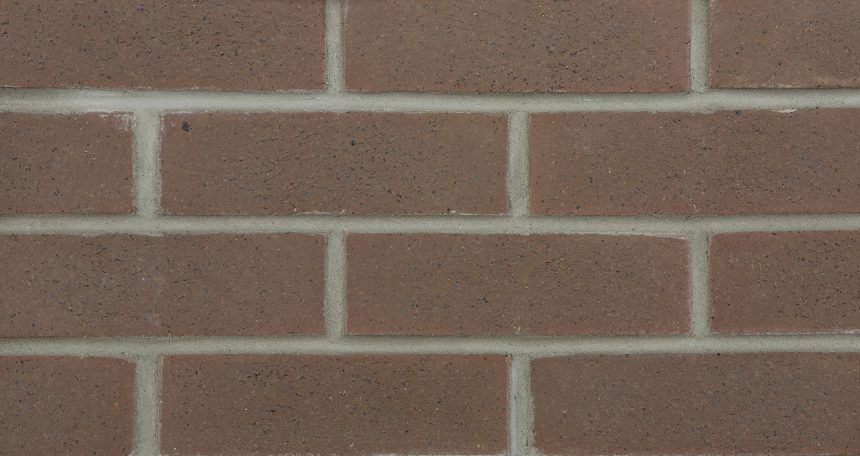 A close up of a brick wall with a white border.