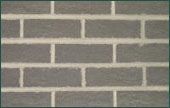 A close up of a brick wall with white bricks.