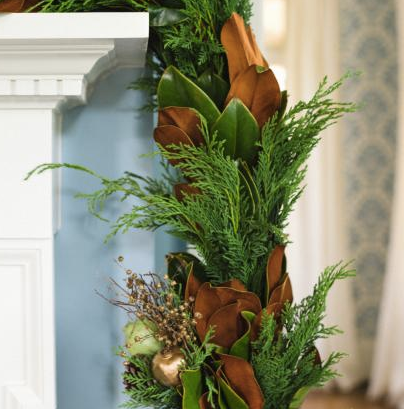 A christmas garland is hanging on a fireplace mantle