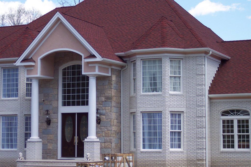 A large white house with a red roof