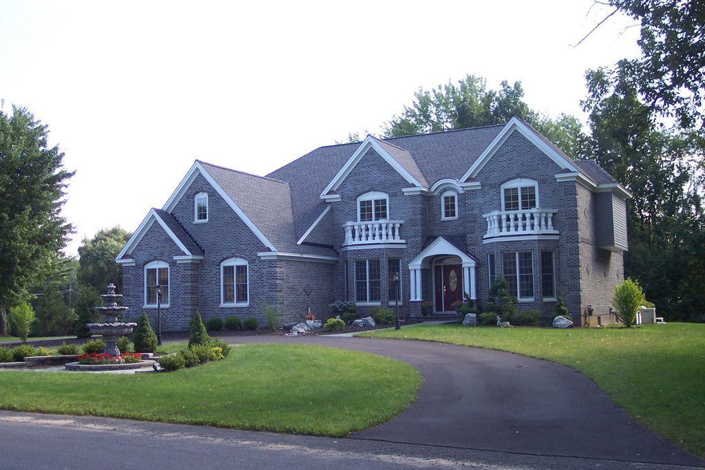 A large house with a driveway leading to it