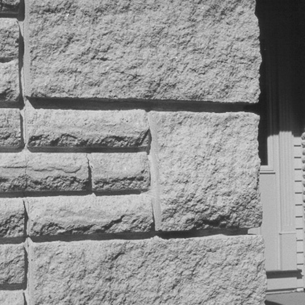 A black and white photo of a stone wall