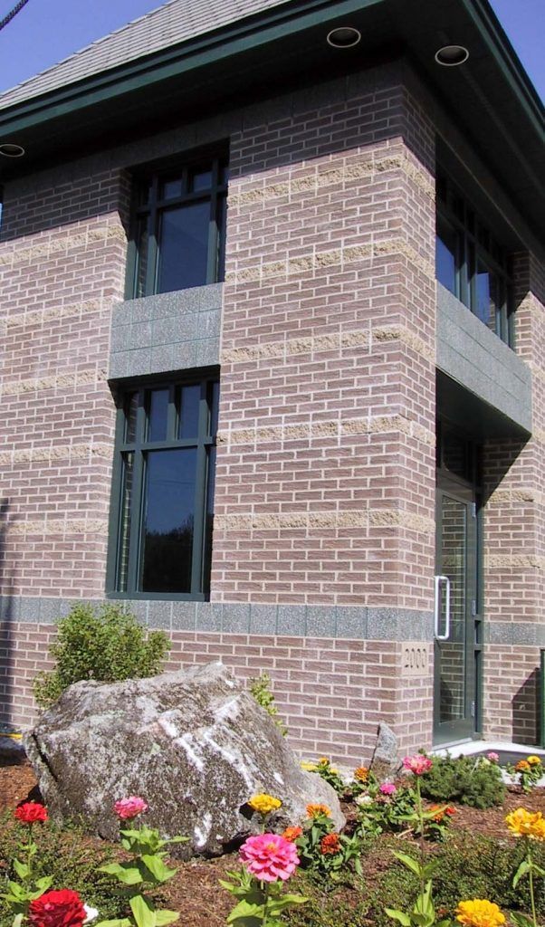 A brick building with flowers in front of it
