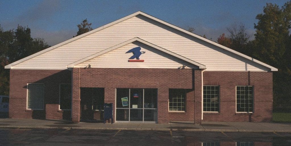 A brick building with a white roof and a bird on it