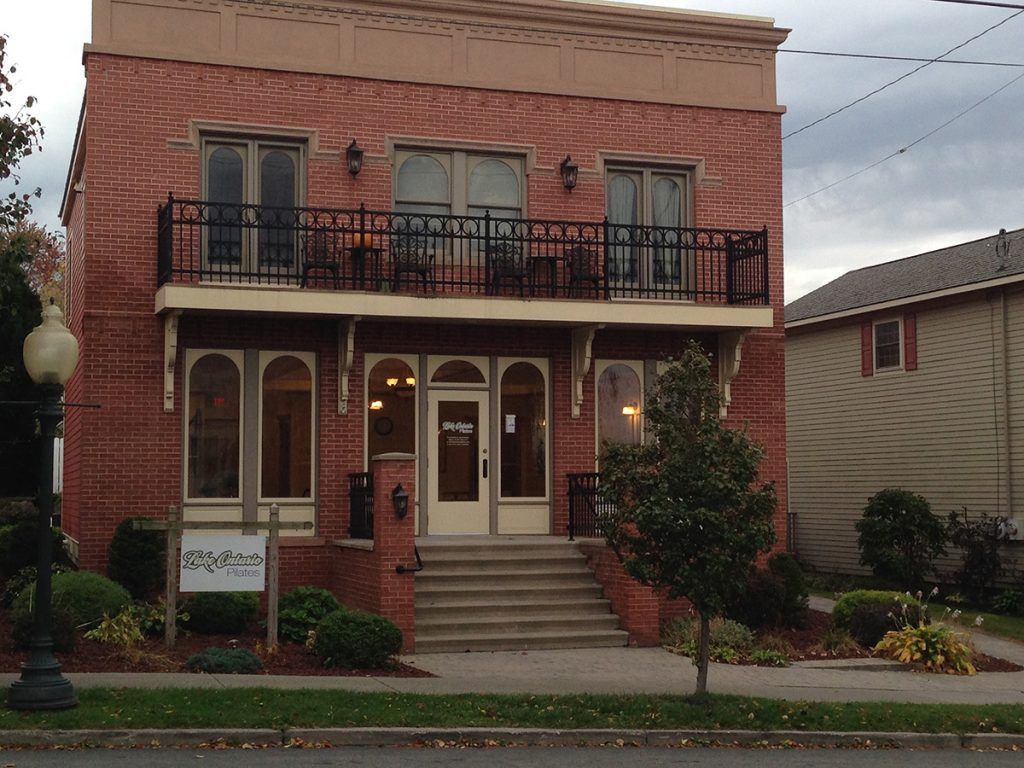 A large brick building with a balcony and stairs