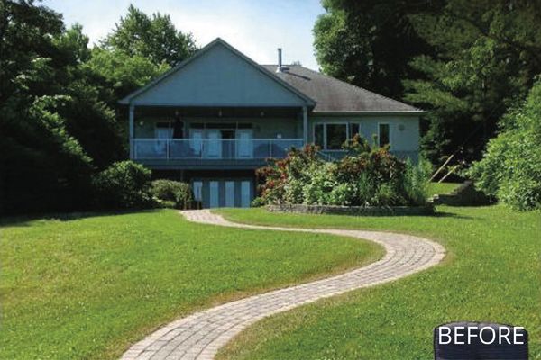 A before picture of a house with a brick walkway