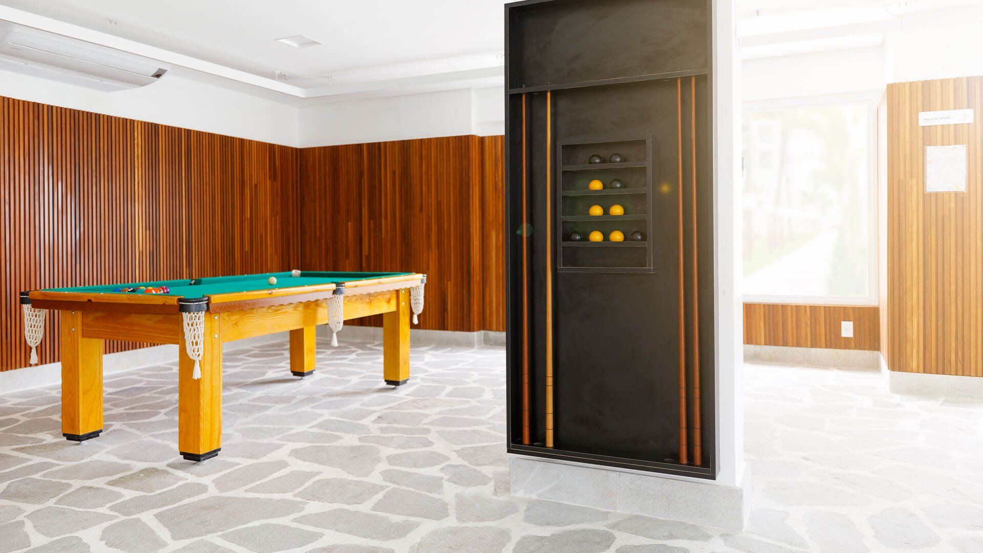 Há uma mesa de sinuca no meio da sala.