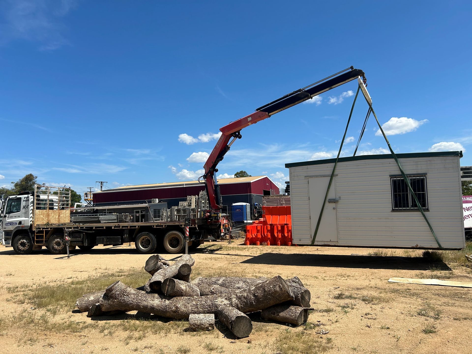 A Tow Truck With Two Tractors On The Back Is Parked — Kingaroy Crane Trucks & Equipment Hire In Murgon, QLD