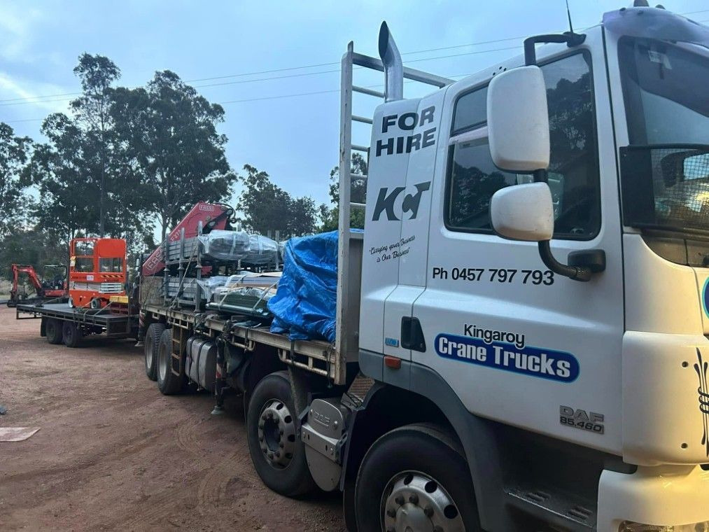 A White Truck With A Blue Tarp On The Back Is Parked — Kingaroy Crane Trucks & Equipment Hire In Goomeri, QLD
