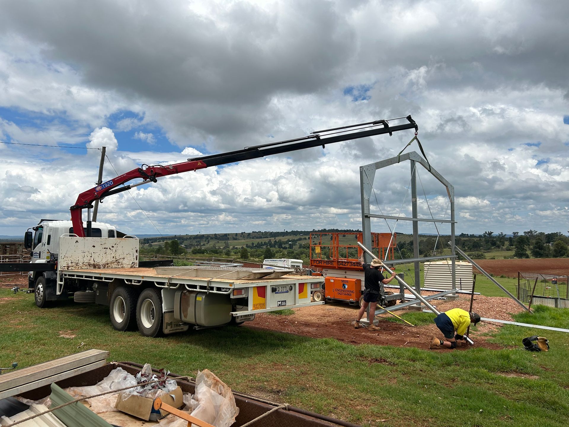 A White Truck With A Crane On The Back Is Parked — Kingaroy Crane Trucks & Equipment Hire In Mundubbera, QLD