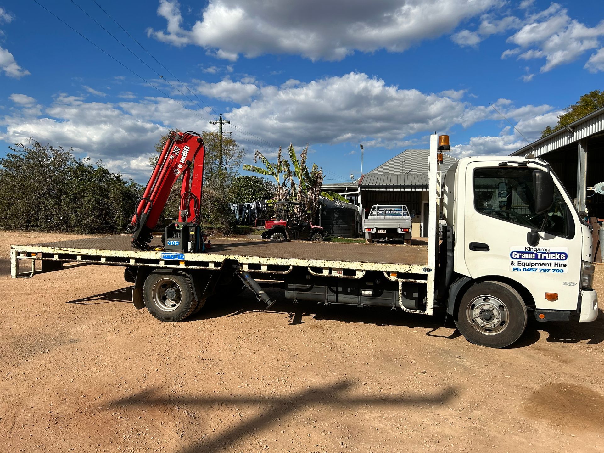 A Crane Is Lifting A Large Piece Of Wood From A Truck — Kingaroy Crane Trucks & Equipment Hire In Kingaroy, QLD