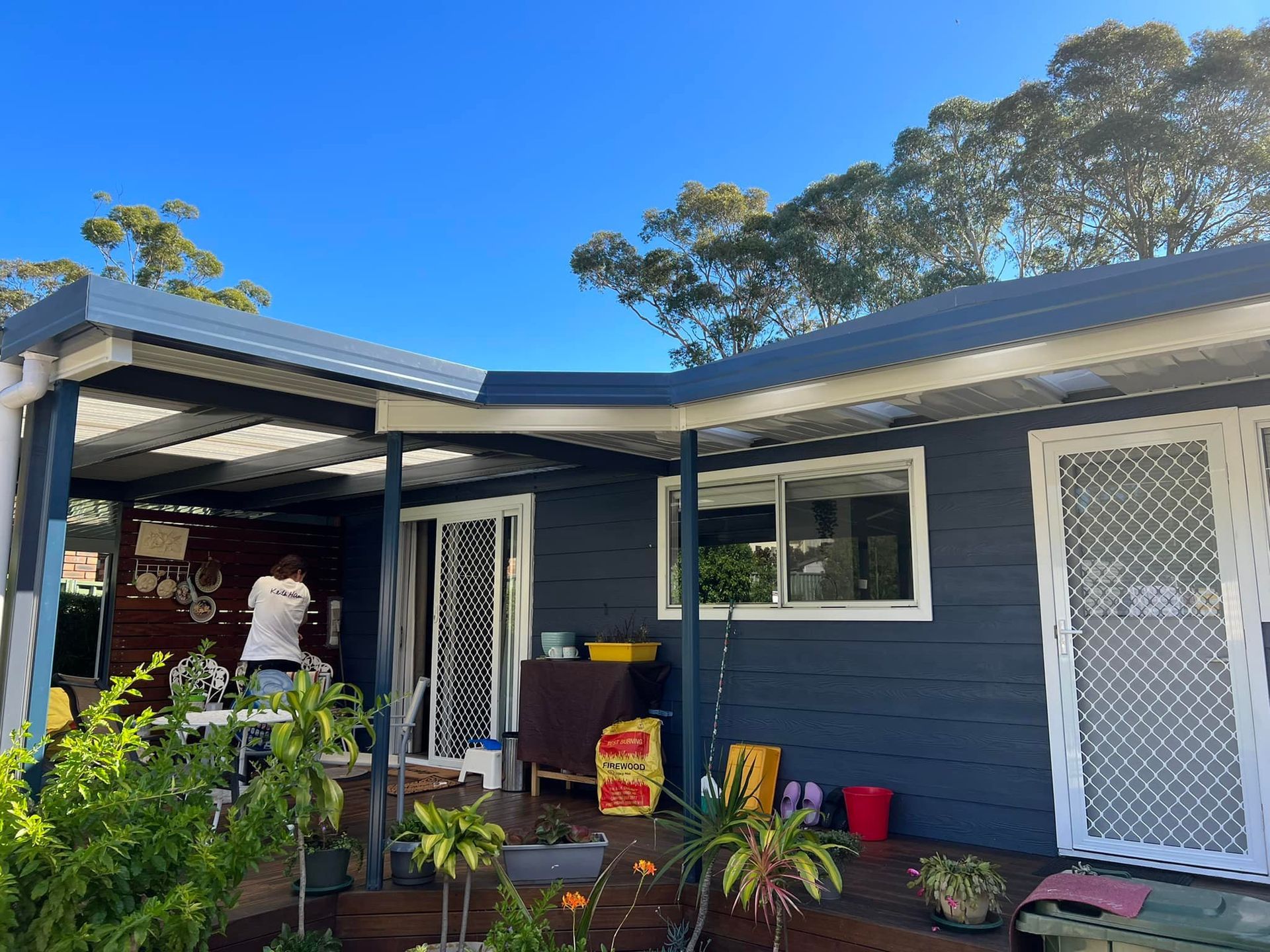 A house with a porch and a blue sky in the background