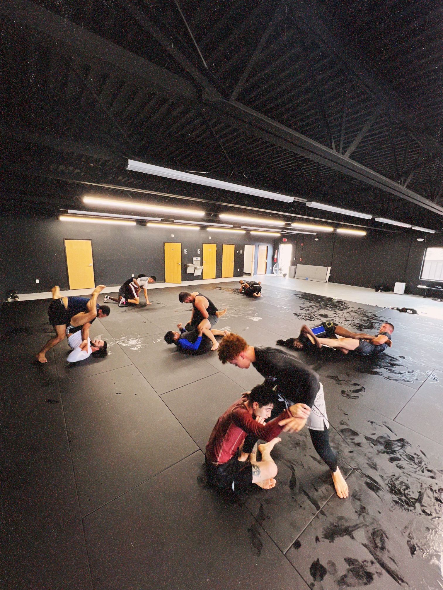 Adults practicing grappling drills at Connecticut Submission Grappling in Bridgeport, CT to build measurable progress.