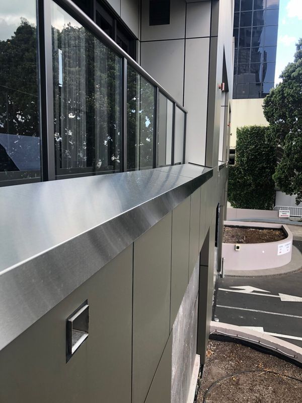 A large roll of metal is being rolled in a factory.