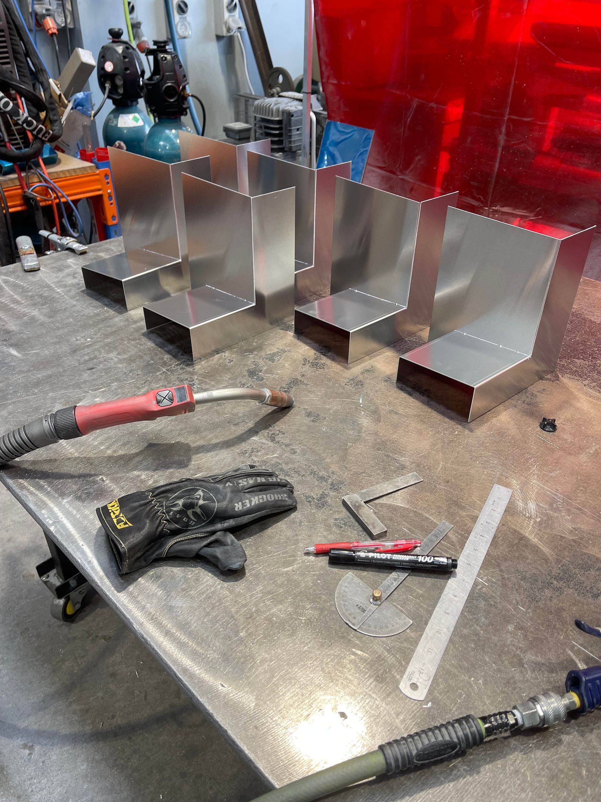 A person is grinding a piece of metal with a grinder.