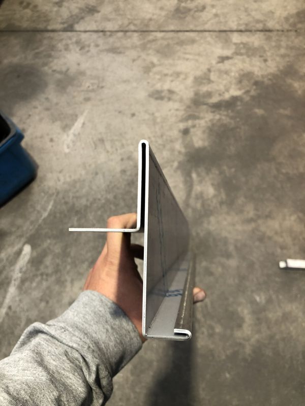 A person is holding a piece of metal in their hand.