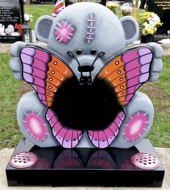 bear holding a butterfly headstone