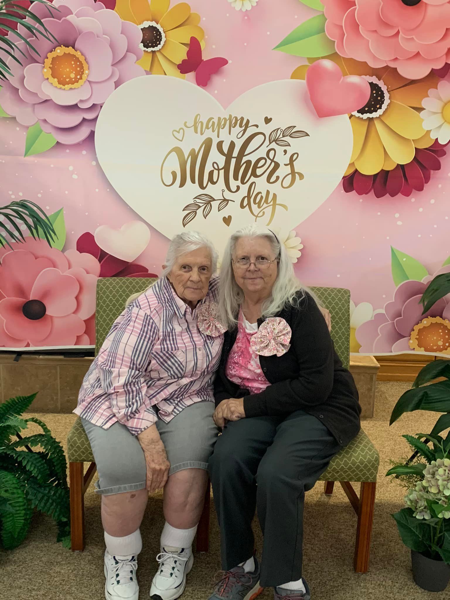 Row of houses at dusk with the moon in a pink and blue sky.