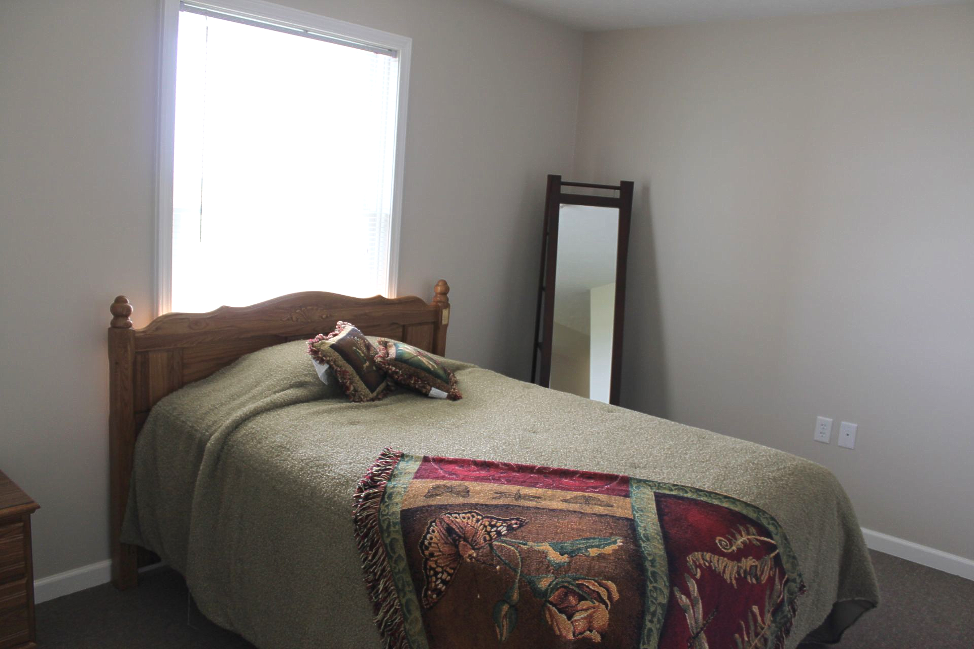 Row of houses at dusk with the moon in a pink and blue sky.
