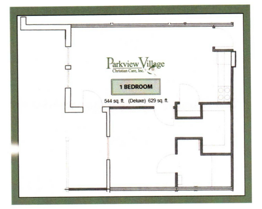 Rainbow arches over a residential area with a brick building and parked cars.