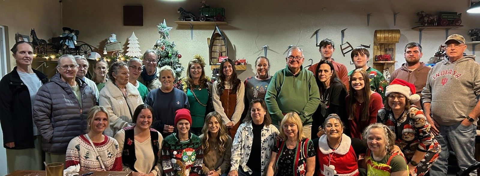 Rainbow arches over a residential area with a brick building and parked cars.