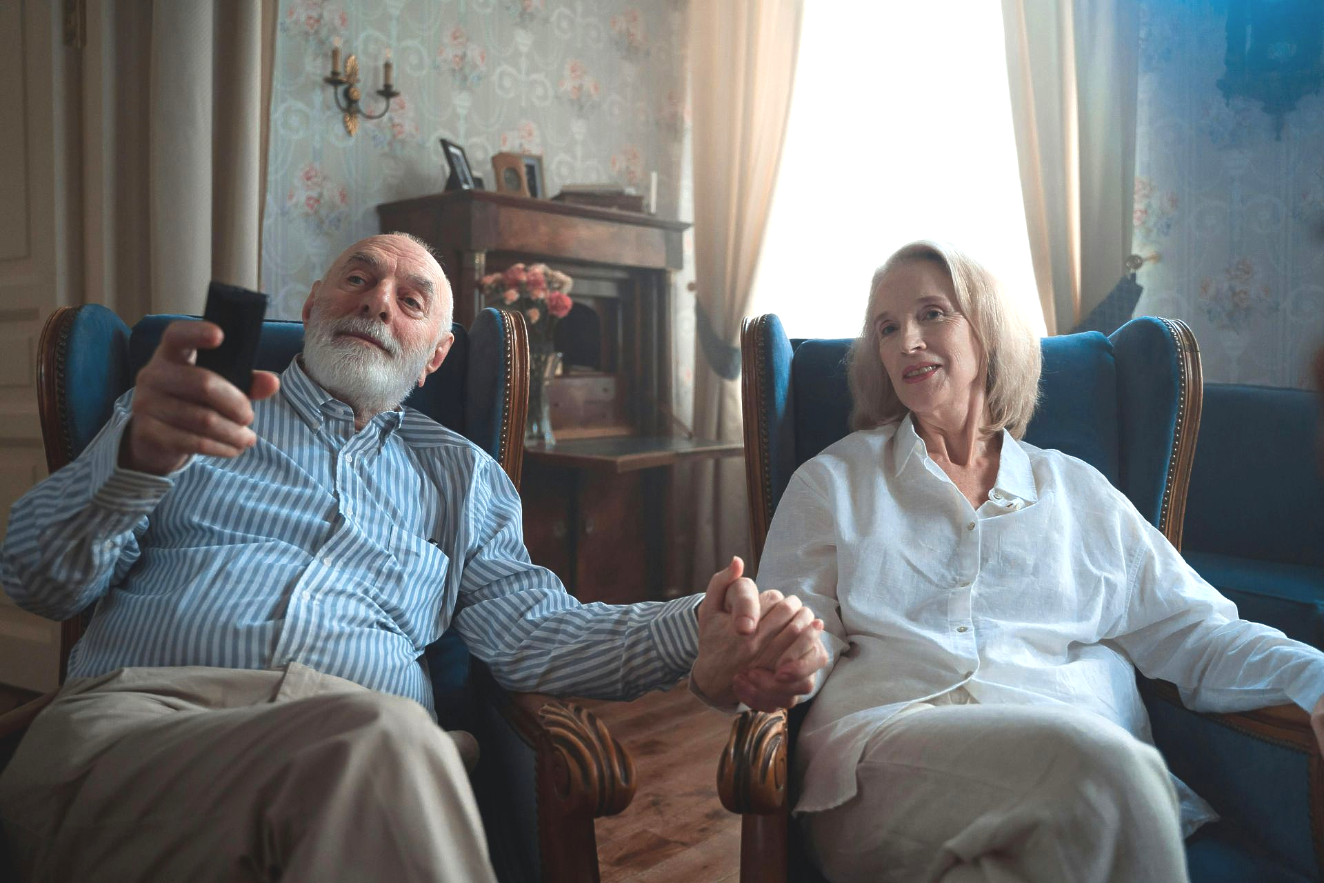 Row of houses at dusk with the moon in a pink and blue sky.