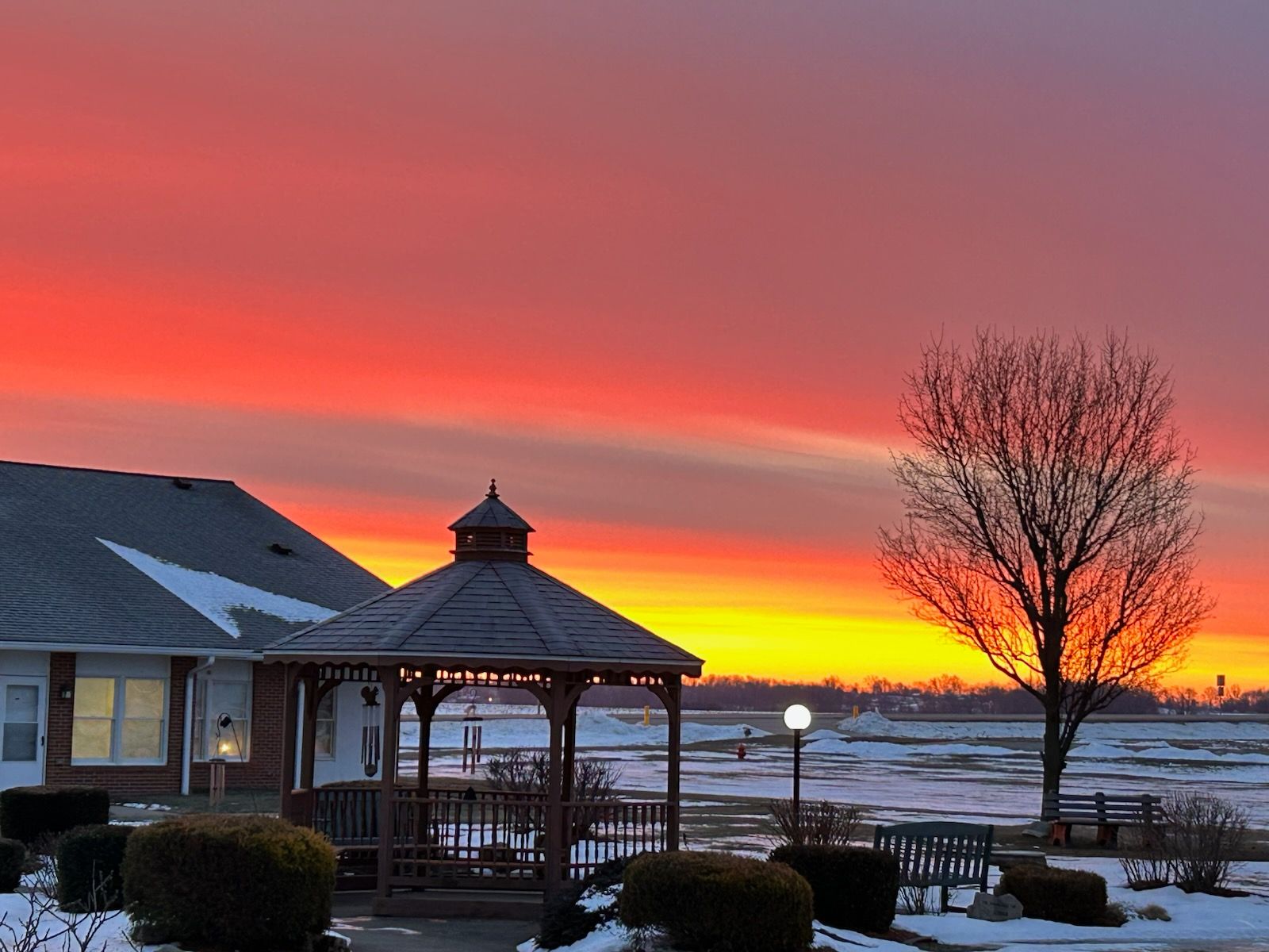 Small apartment: kitchen with cabinets, fridge, dining table with chairs, and two white doors.
