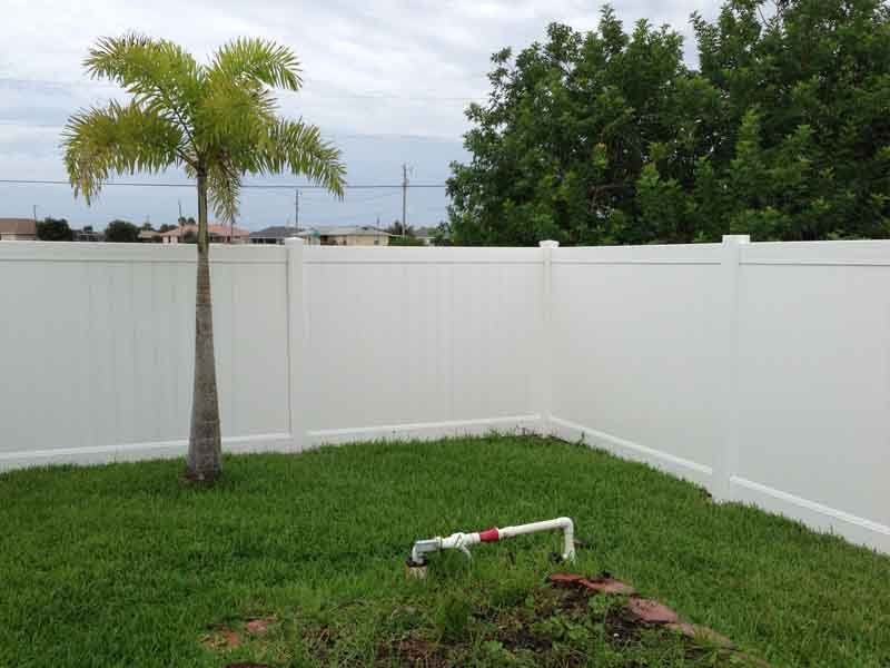 Fence Contractor — White Fence With Tree in Cape Coral, FL