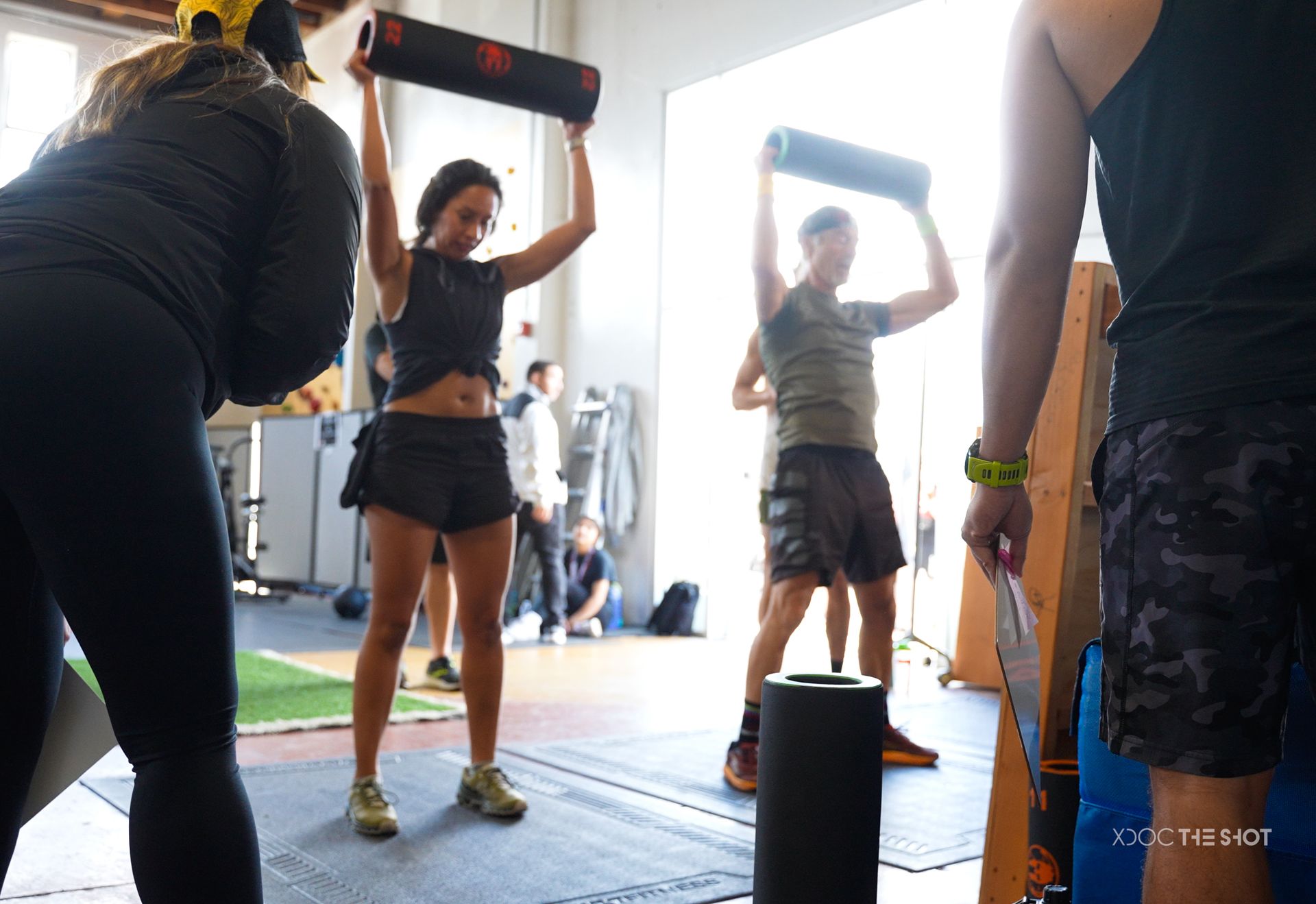 A group of people are doing exercises in a gym.