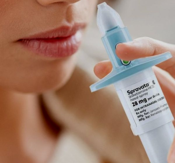 Person administering Spravato nasal spray to themselves.