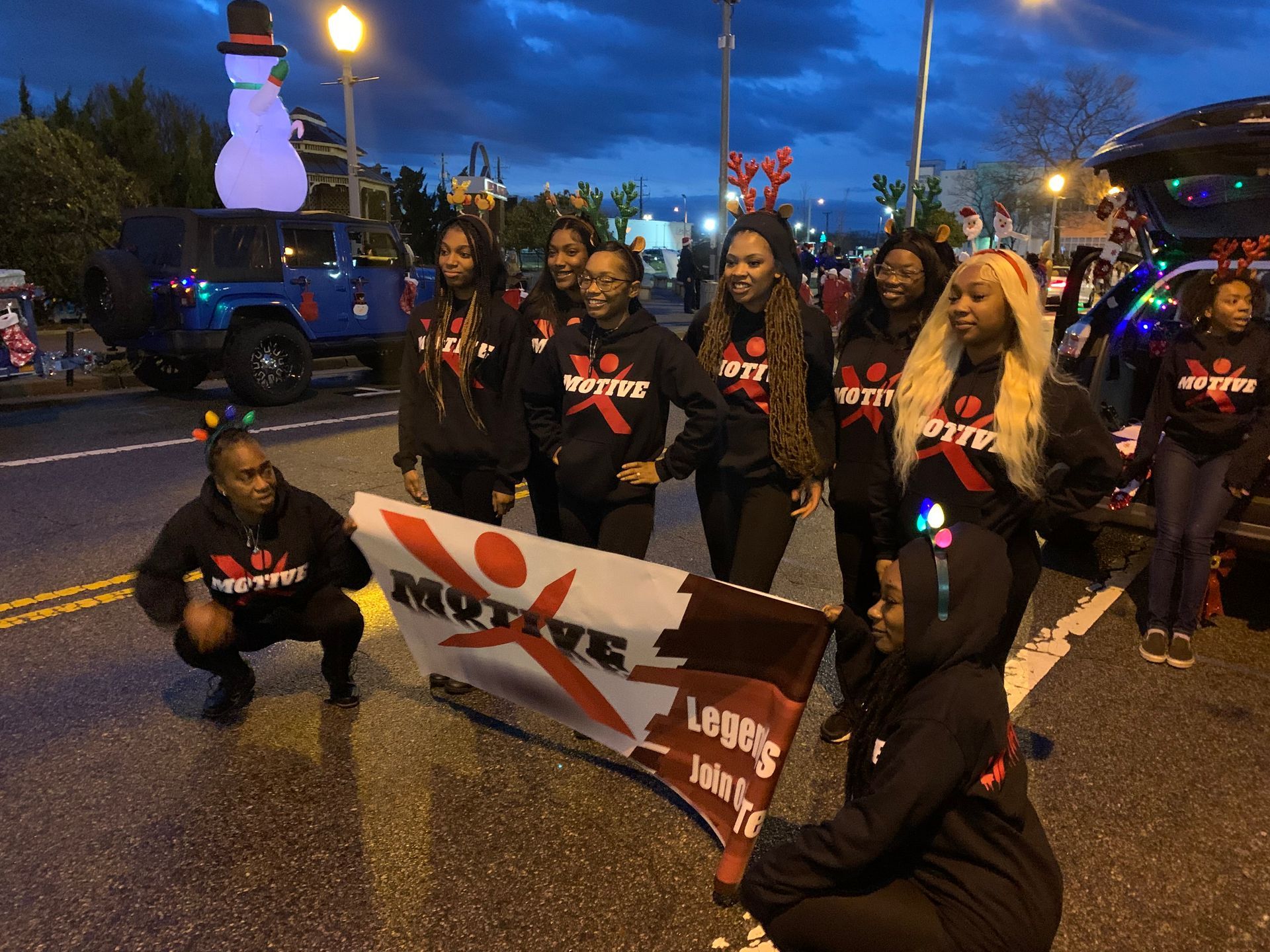 Our Dance Team holding a banner that says