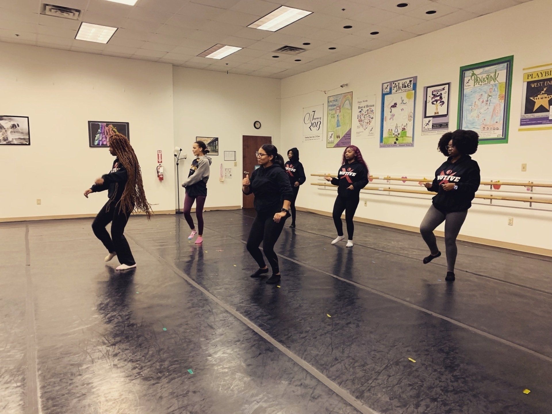 A group of women are dancing in a dance studio.