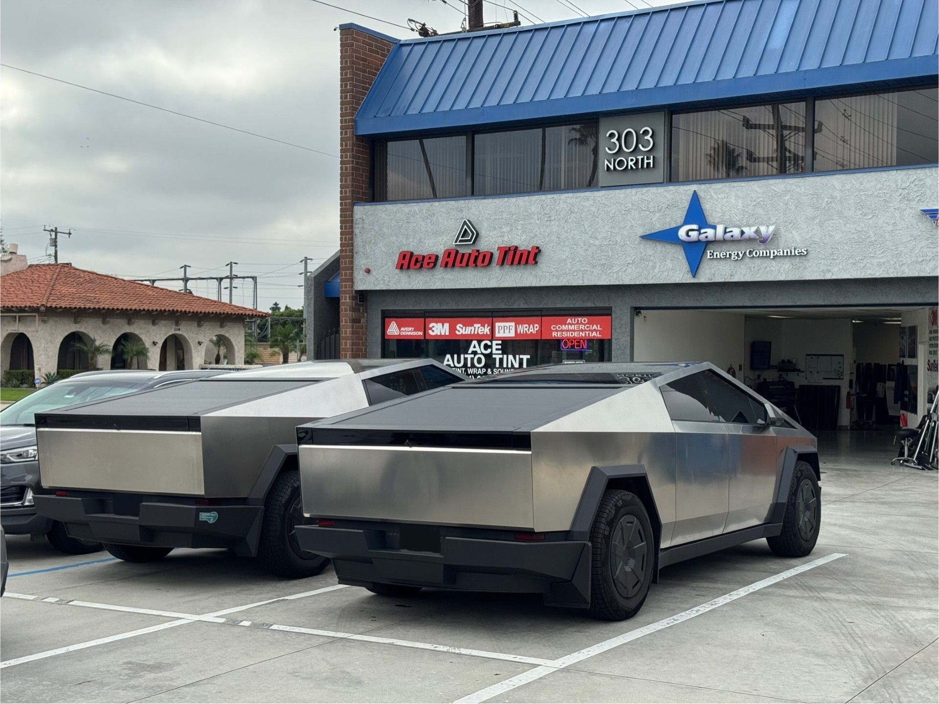 Two cybertrucks facing our shop.