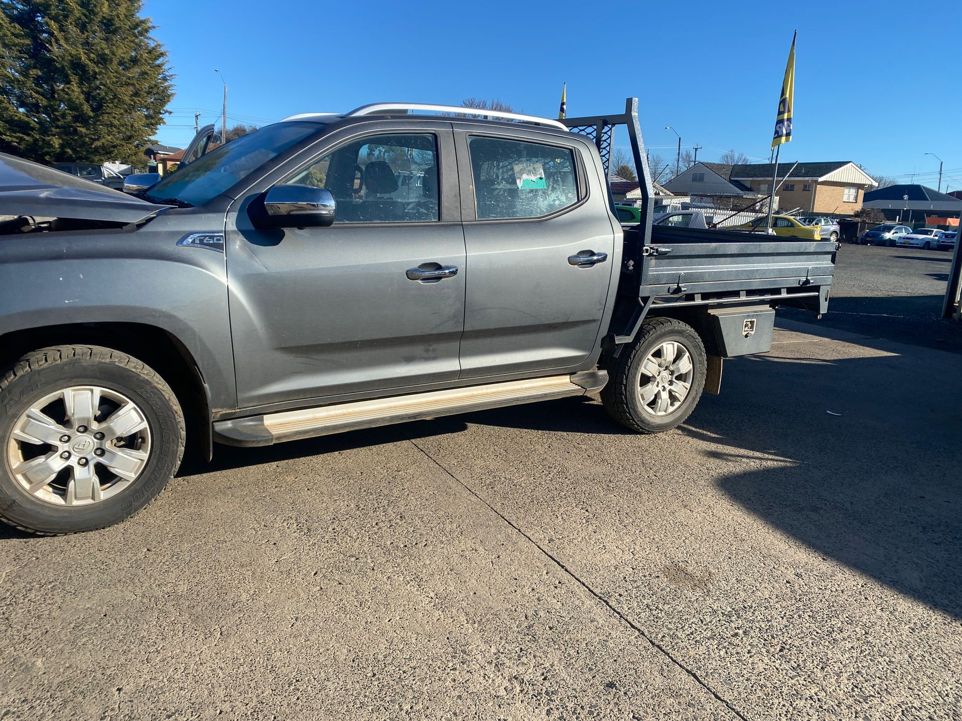 Gray Pickup Truck With a Flatbed Parked on Pavement — Great Western Auto Wreckers in Orange, NSW
