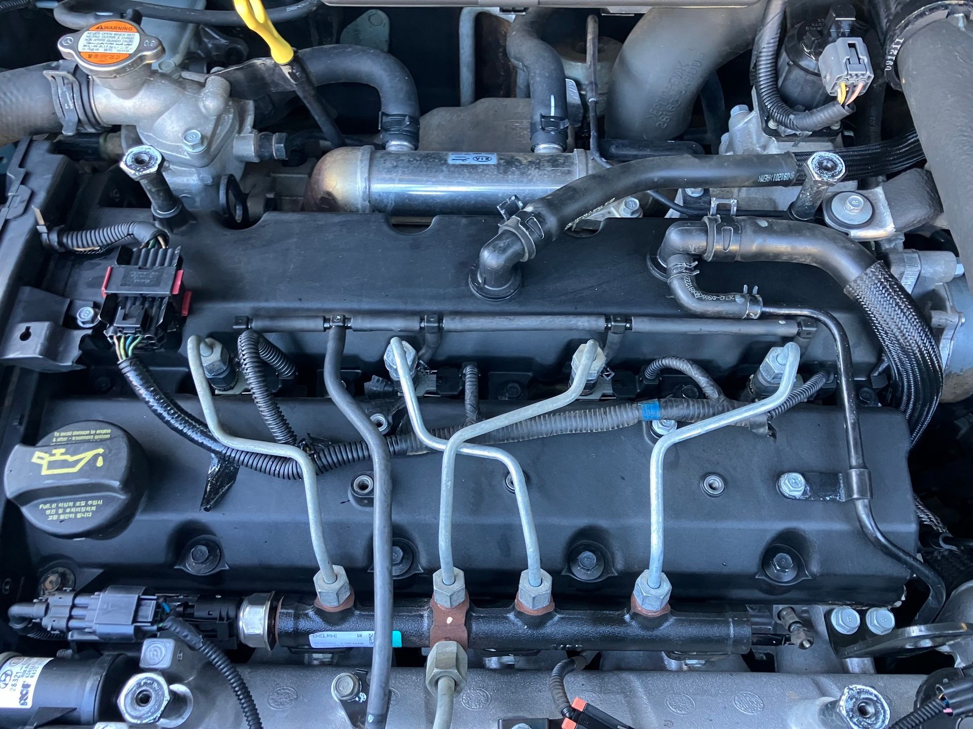 Car Engine With Black Cover Fuel Lines and Various Components — Great Western Auto Wreckers in Orange, NSW