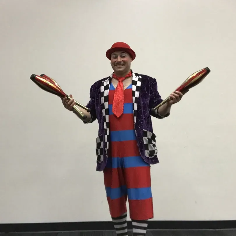 Milanus Circus, Miami, FL, juggler in clown costume.